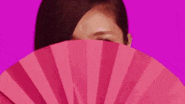 three women are standing next to each other on a pink background