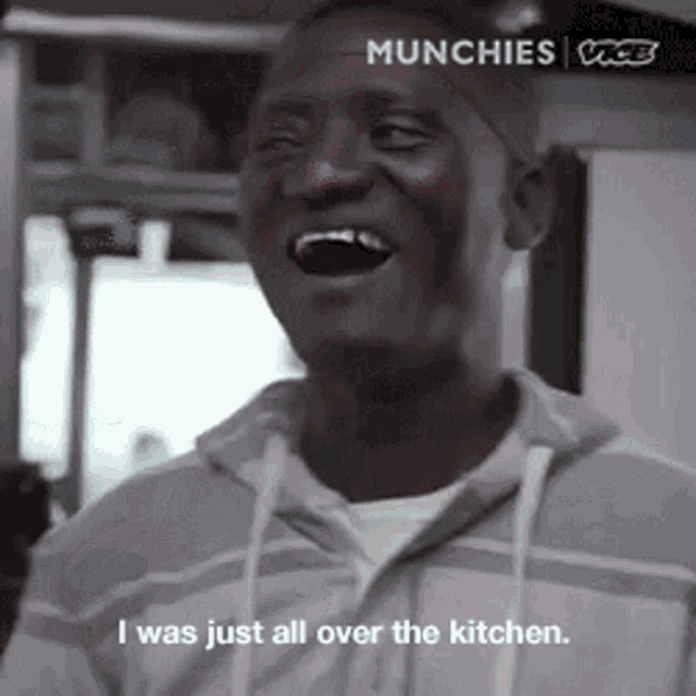 a man is laughing with the words i was just all over the kitchen behind him