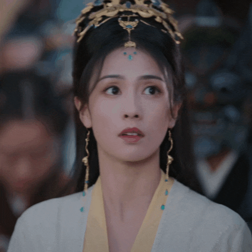 a close up of a woman wearing a crown