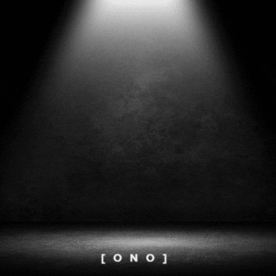a spotlight is shining on a black background in a dark room .