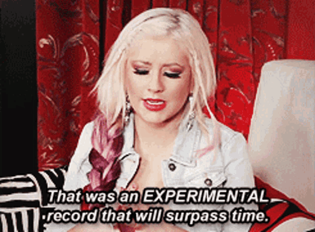 a blonde woman is sitting on a couch with the words that was an experimental record that will surpass time