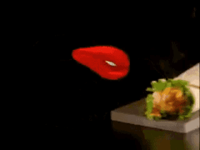 a flamethrower chicken wrap with lettuce and cheese on a cutting board