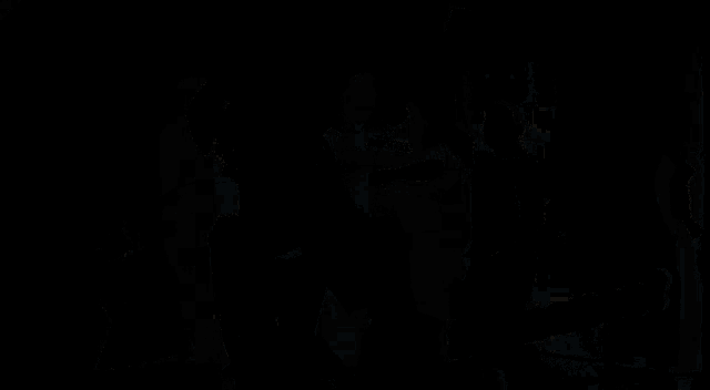 a group of people are dancing in a dark room with the word flamenco on the bottom