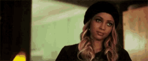 the woman is wearing a black hat and a black shirt .