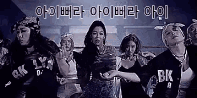 a group of people are standing next to each other in a dark room .
