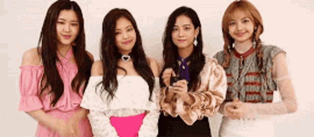 a group of young women are standing next to each other .