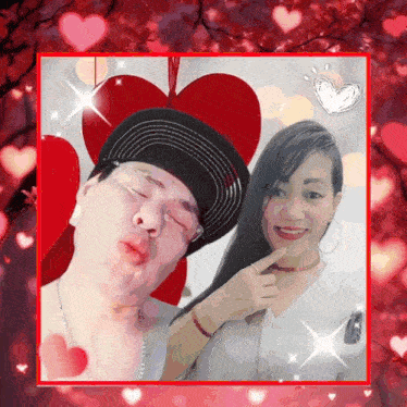 a man and a woman are posing for a picture in front of a heart shaped background