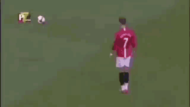 a soccer player in a white jersey with the number 7 on it is kicking a soccer ball .