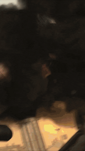 a close up of a person 's face with a blurred background and a few lines
