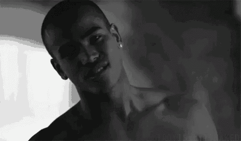 a black and white photo of a man without a shirt