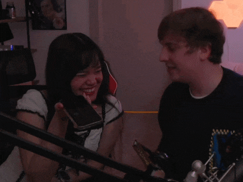 a man and woman are kissing in front of a microphone