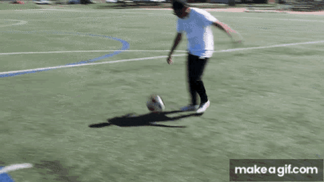 a person kicking a soccer ball on a field