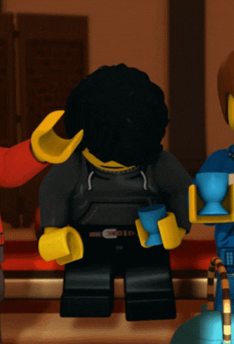 a lego figure holding a blue cup in front of his face