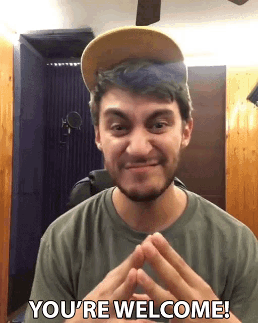 a man wearing a hat and a green shirt says " you 're welcome "