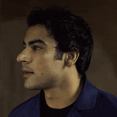 a close up of a man 's face with a dark background