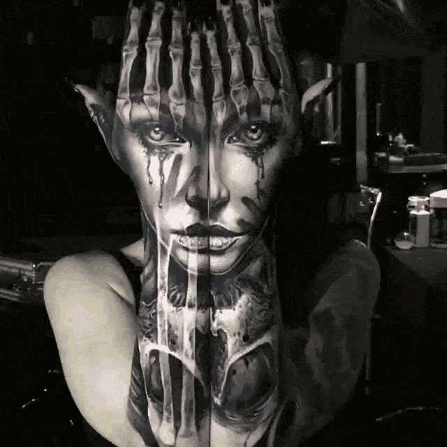 a woman has a tattoo of a skeleton hand covering her face