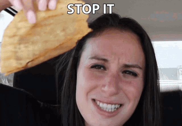 a woman in a car with a taco on her head and the words stop it above her