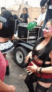 a woman wearing a mask is dancing with a man