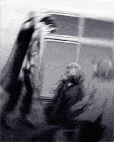a blurry black and white photo of a person walking
