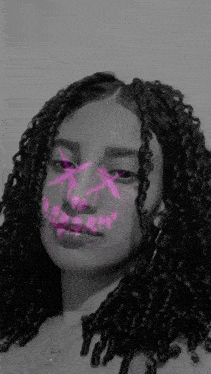 a woman with curly hair and dreadlocks is wearing a pink mask with a skull on her face .