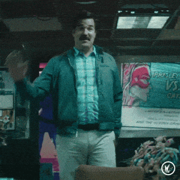 a man standing in front of a poster that says presley vs. gay