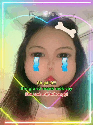 a girl with tears running down her face is surrounded by a heart and a bone