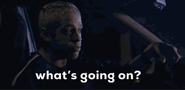 a man driving a car with the words " what 's going on " above him