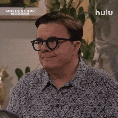 a man wearing glasses is smiling in a hulu ad
