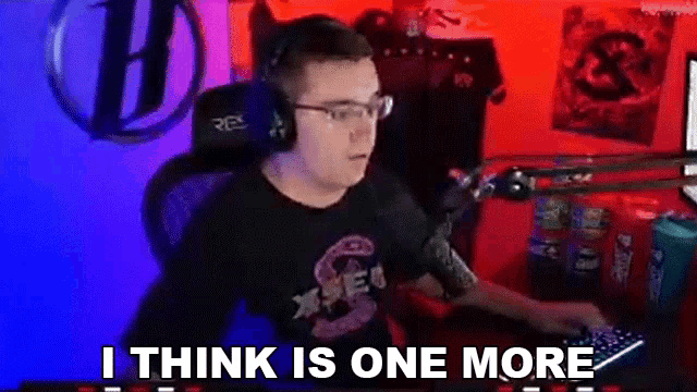 a man wearing headphones and glasses is sitting in front of a computer with the words `` i think is one more '' .