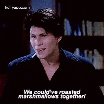 a man with a cigarette in his mouth is talking about roasting marshmallows together .
