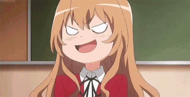 a girl is making a funny face in front of a blackboard .