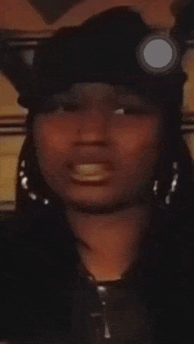 a close up of a woman wearing a black hat