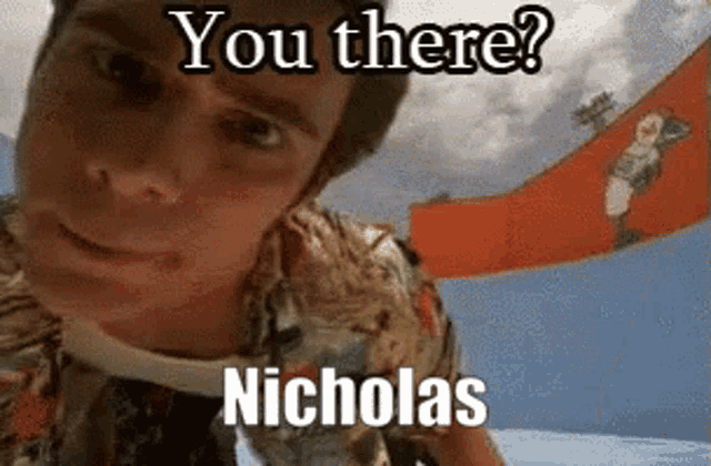 a man in a hawaiian shirt is looking at the camera with the caption " you there nicholas "