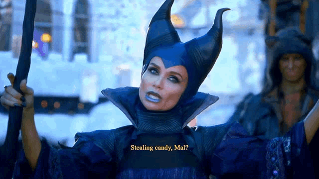 a woman in a maleficent costume is holding a sword and says " stealing candy mai "