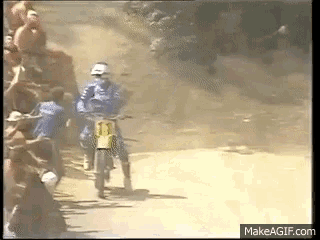 a man riding a dirt bike has the number 13 on his shirt