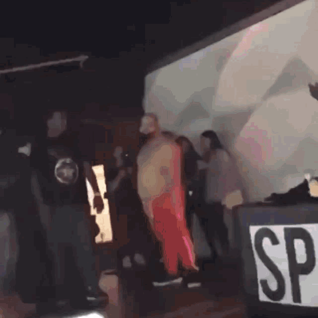 a man in red pants is standing in front of a sign that says sd