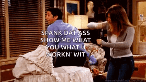 a man and a woman are having a fight in a living room with the woman saying spank dat ass