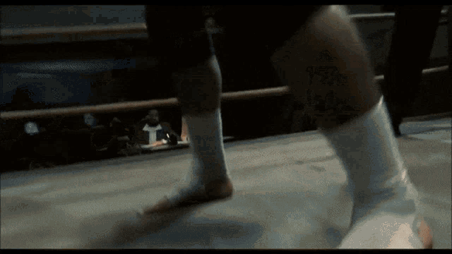 a boxer 's leg is wrapped in a bandage in a ring
