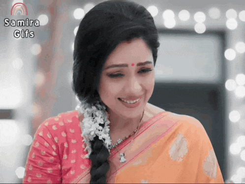 a woman in a pink and orange saree is smiling with the words samira gifs below her