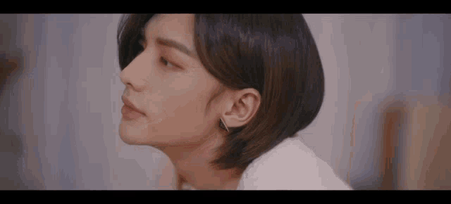 a close up of a person 's face with a white sweater on