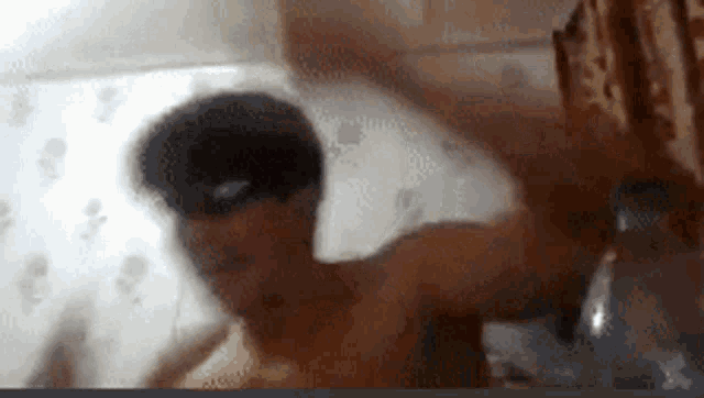 a blurry picture of a man in a bathtub with his eyes closed
