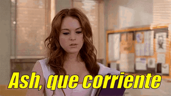 a woman with red hair is holding a book and says ash que corriente .