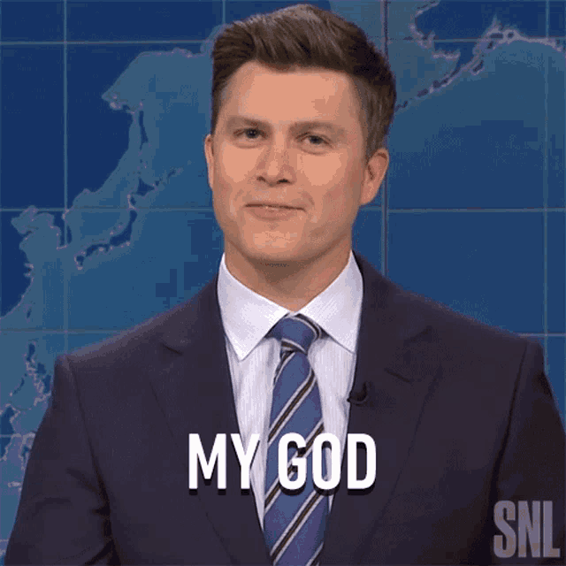 a man in a suit and tie says " my god " in front of a map