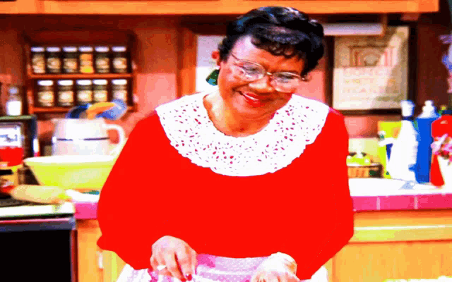 a woman in a kitchen with a sign that says " home sweet home " on it