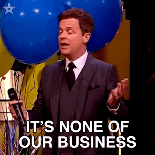 a man in a suit and tie is holding a microphone and says " it 's none of our business "