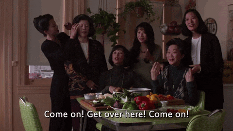 a group of women standing around a table with the words come on get over here come on on the bottom
