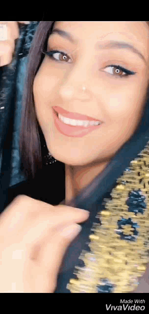 a close up of a woman 's face with a veil on her head .