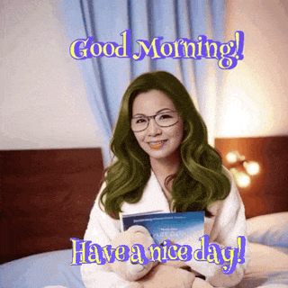 a woman with green hair is sitting on a bed holding a teddy bear and a book and says good morning