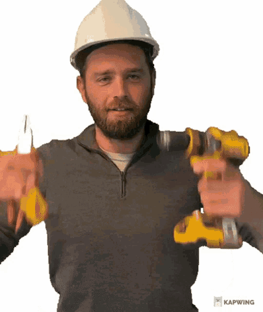 a man in a hard hat is holding a drill and pliers