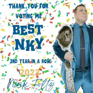 a man in a suit and tie is holding a belt that says ' best nky ' on it